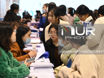 College student job seekers are communicating with representatives of employers at a college employment fair in Fuyang, Anhui Province, Chin...