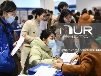 College student job seekers are communicating with representatives of employers at a college employment fair in Fuyang, Anhui Province, Chin...