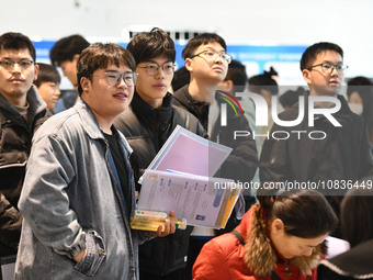 College student job seekers are communicating with representatives of employers at a college employment fair in Fuyang, Anhui Province, Chin...