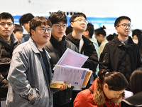 College student job seekers are communicating with representatives of employers at a college employment fair in Fuyang, Anhui Province, Chin...