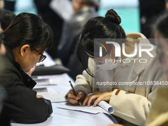 College student job seekers are communicating with representatives of employers at a college employment fair in Fuyang, Anhui Province, Chin...