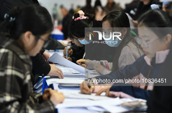 College student job seekers are communicating with representatives of employers at a college employment fair in Fuyang, Anhui Province, Chin...