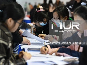 College student job seekers are communicating with representatives of employers at a college employment fair in Fuyang, Anhui Province, Chin...