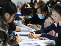 College student job seekers are communicating with representatives of employers at a college employment fair in Fuyang, Anhui Province, Chin...