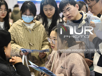 College student job seekers are communicating with representatives of employers at a college employment fair in Fuyang, Anhui Province, Chin...