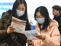 College student job seekers are communicating with representatives of employers at a college employment fair in Fuyang, Anhui Province, Chin...