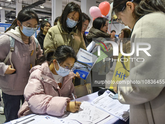 College student job seekers are communicating with representatives of employers at a college employment fair in Fuyang, Anhui Province, Chin...