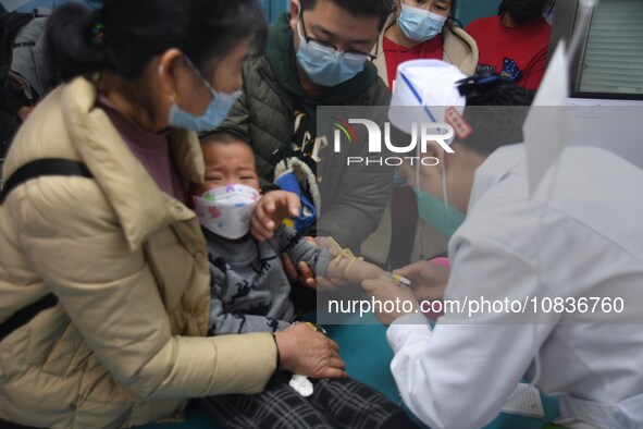 Parents are taking their children for infusion treatment at a hospital in Shenyang, Liaoning province, China, on December 8, 2023. 