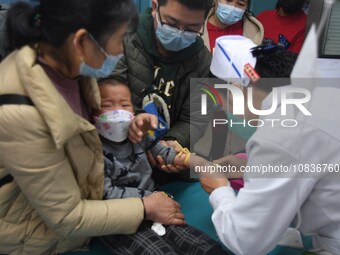 Parents are taking their children for infusion treatment at a hospital in Shenyang, Liaoning province, China, on December 8, 2023. (