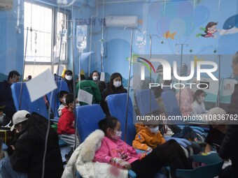 Parents are taking their children for infusion treatment at a hospital in Shenyang, Liaoning province, China, on December 8, 2023. (