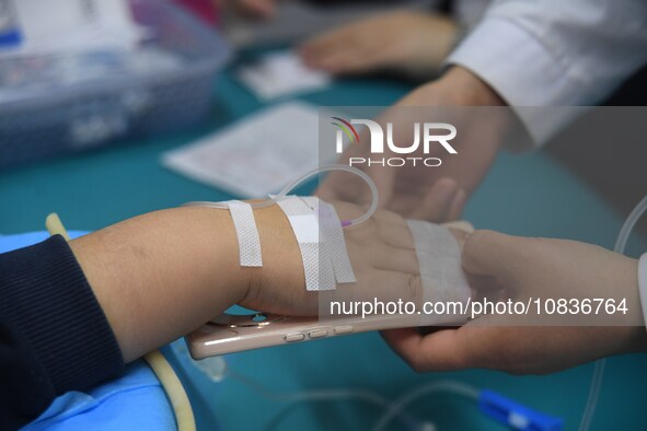 Parents are taking their children for infusion treatment at a hospital in Shenyang, Liaoning province, China, on December 8, 2023. 