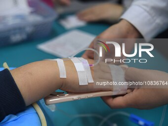 Parents are taking their children for infusion treatment at a hospital in Shenyang, Liaoning province, China, on December 8, 2023. (