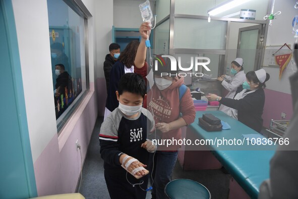 Parents are taking their children for infusion treatment at a hospital in Shenyang, Liaoning province, China, on December 8, 2023. 