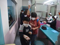 Parents are taking their children for infusion treatment at a hospital in Shenyang, Liaoning province, China, on December 8, 2023. (