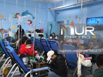 Parents are taking their children for infusion treatment at a hospital in Shenyang, Liaoning province, China, on December 8, 2023. (