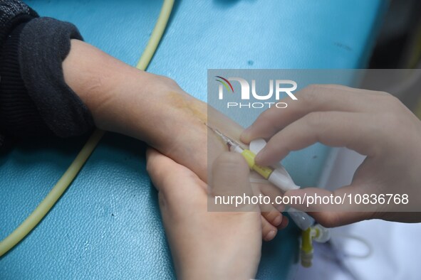 Parents are taking their children for infusion treatment at a hospital in Shenyang, Liaoning province, China, on December 8, 2023. 