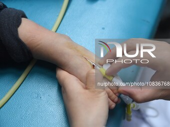 Parents are taking their children for infusion treatment at a hospital in Shenyang, Liaoning province, China, on December 8, 2023. (