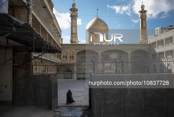 A veiled Iranian woman is walking at the holy shrine in the flooded village of Imamzadeh Davood, in the northwestern part of Tehran, on Dece...