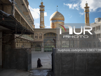 A veiled Iranian woman is walking at the holy shrine in the flooded village of Imamzadeh Davood, in the northwestern part of Tehran, on Dece...