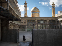 A veiled Iranian woman is walking at the holy shrine in the flooded village of Imamzadeh Davood, in the northwestern part of Tehran, on Dece...