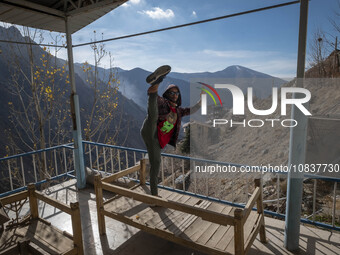 An Iranian man is exercising on a balcony of a cafe near the flooded village of Imamzadeh Davood in the northwestern part of Tehran, on Dece...