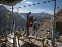 An Iranian man is exercising on a balcony of a cafe near the flooded village of Imamzadeh Davood in the northwestern part of Tehran, on Dece...