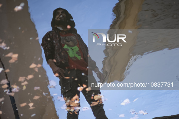 An Iranian man is standing next to a pool on a balcony of a cafe near the flooded village of Imamzadeh Davood in the northwestern part of Te...