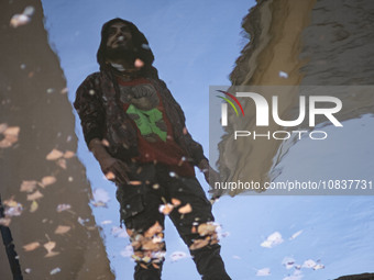 An Iranian man is standing next to a pool on a balcony of a cafe near the flooded village of Imamzadeh Davood in the northwestern part of Te...