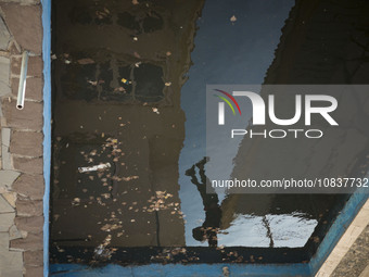 An Iranian man is exercising next to a pool on a balcony of a cafe near the flooded village of Imamzadeh Davood in the northwestern part of...