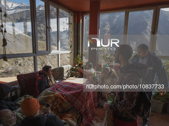 Iranian youths are sitting at a cafe near the flooded village of Imamzadeh Davood in the northwestern part of Tehran, on December 8, 2023, m...