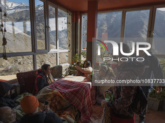 Iranian youths are sitting at a cafe near the flooded village of Imamzadeh Davood in the northwestern part of Tehran, on December 8, 2023, m...