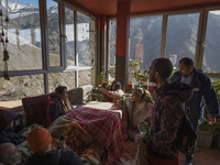 Iranian youths are sitting at a cafe near the flooded village of Imamzadeh Davood in the northwestern part of Tehran, on December 8, 2023, m...