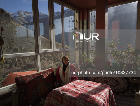 An Iranian woman is taking a selfie while sitting at a cafe near the flooded village of Imamzadeh Davood in the northwestern part of Tehran,...