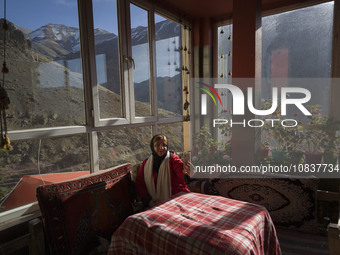 An Iranian woman is taking a selfie while sitting at a cafe near the flooded village of Imamzadeh Davood in the northwestern part of Tehran,...