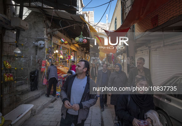 Iranian tourists are walking through a bazaar while visiting the flooded village of Imamzadeh Davood in the northwestern part of Tehran, Ira...