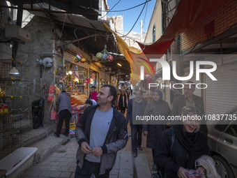 Iranian tourists are walking through a bazaar while visiting the flooded village of Imamzadeh Davood in the northwestern part of Tehran, Ira...