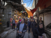 Iranian tourists are walking through a bazaar while visiting the flooded village of Imamzadeh Davood in the northwestern part of Tehran, Ira...