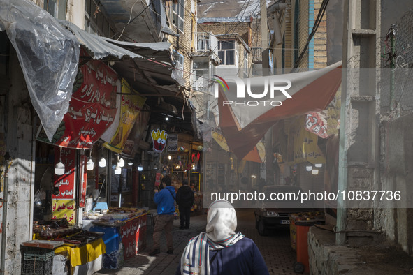 An Iranian woman is walking through a bazaar while visiting the flooded village of Imamzadeh Davood in the northwestern part of Tehran, Iran...