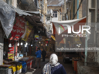 An Iranian woman is walking through a bazaar while visiting the flooded village of Imamzadeh Davood in the northwestern part of Tehran, Iran...