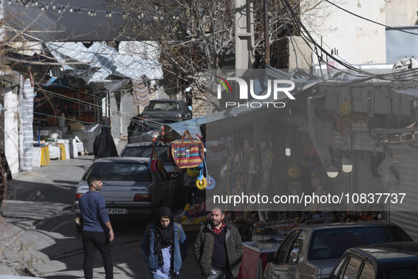 Iranian tourists are walking through a bazaar while visiting the flooded village of Imamzadeh Davood in the northwestern part of Tehran, Ira...