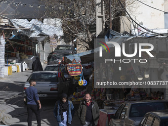 Iranian tourists are walking through a bazaar while visiting the flooded village of Imamzadeh Davood in the northwestern part of Tehran, Ira...