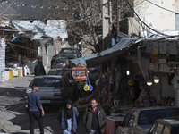 Iranian tourists are walking through a bazaar while visiting the flooded village of Imamzadeh Davood in the northwestern part of Tehran, Ira...