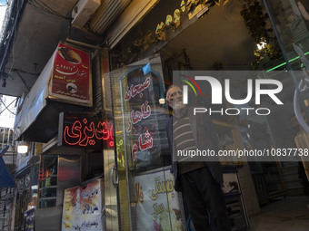 An elderly Iranian man is standing at the door of his restaurant in a bazaar within the flooded village of Imamzadeh Davood in the northwest...