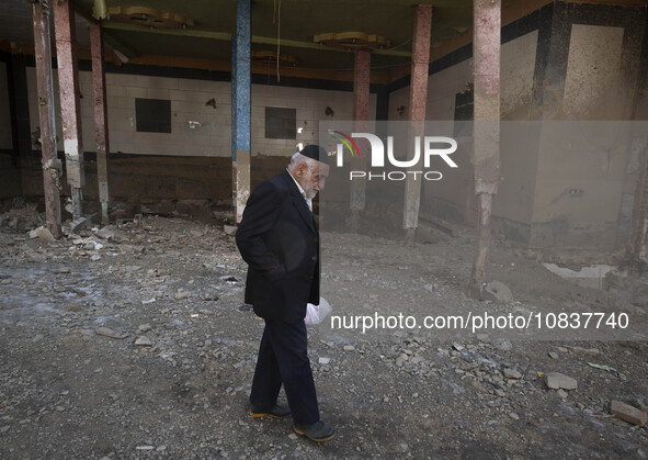 An elderly Iranian man is walking past a destroyed shop while visiting the flooded village of Imamzadeh Davood in the northwestern part of T...