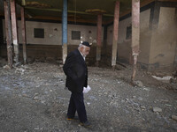 An elderly Iranian man is walking past a destroyed shop while visiting the flooded village of Imamzadeh Davood in the northwestern part of T...