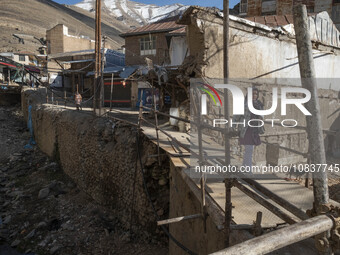 An Iranian woman is walking past destroyed shops along a collapsed street while visiting the flooded village of Imamzadeh Davood in the nort...