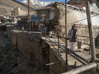 An Iranian woman is walking past destroyed shops along a collapsed street while visiting the flooded village of Imamzadeh Davood in the nort...