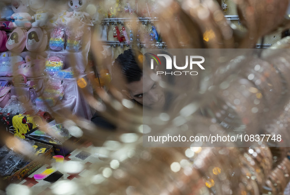 An Iranian salesman is sitting at his shop in a bazaar in the flooded village of Imamzadeh Davood, in the northwestern part of Tehran, on De...