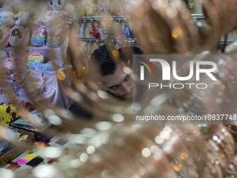 An Iranian salesman is sitting at his shop in a bazaar in the flooded village of Imamzadeh Davood, in the northwestern part of Tehran, on De...