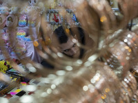 An Iranian salesman is sitting at his shop in a bazaar in the flooded village of Imamzadeh Davood, in the northwestern part of Tehran, on De...